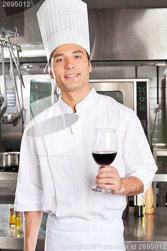 Image of Chef Holding Glass Of Red Wine