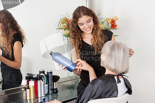 Image of Hairstylist Advising Hair Color To Senior Client