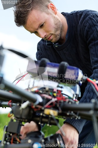 Image of Technician Fixing Camera On UAV Drone