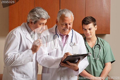 Image of Senior Male Doctor With Colleagues