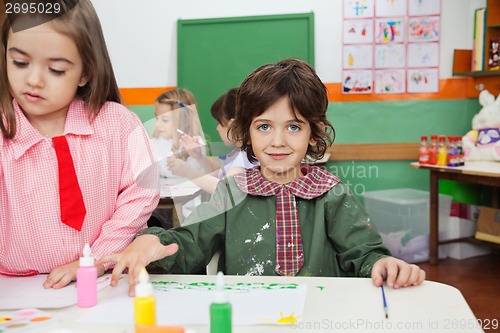 Image of Boy Painting With Friend In Art Class