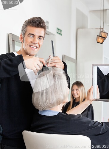 Image of Hairdresser Cutting Client's Hair At Salon