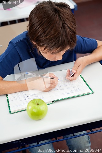 Image of Schoolboy Copying From Cheat Sheet During Examination