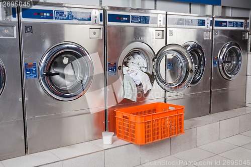 Image of Washing Machine Overloaded With Clothes