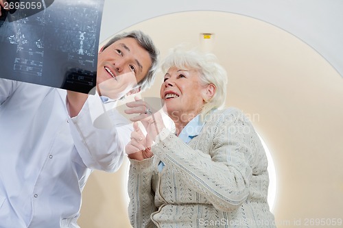 Image of Doctor With Patient Looking At MRI X-ray