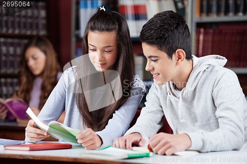 Image of Teenage Friends Studying Together At Desk