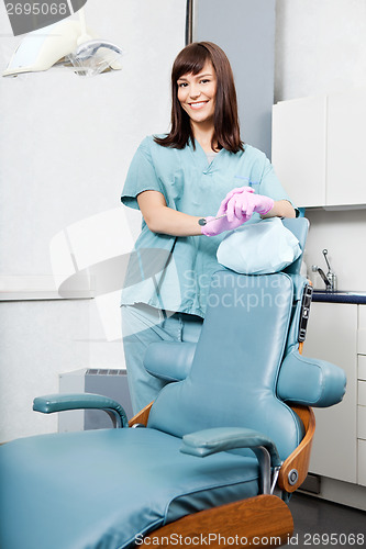 Image of Smiling Female Dentist Standing By Dental Chair At Clinic