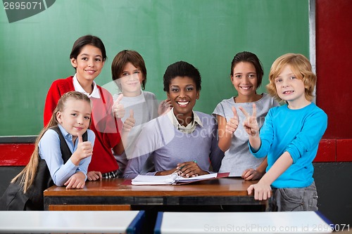 Image of Happy Teacher And Schoolchildren