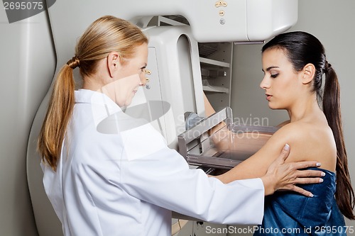 Image of Doctor Assisting Patient Undergoing Mammogram