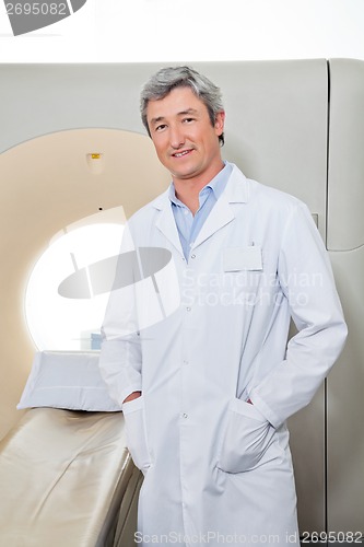 Image of Doctor Standing Next To CT Scanner