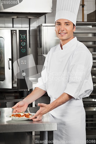 Image of Male Chef With Pasta Dish By Counter