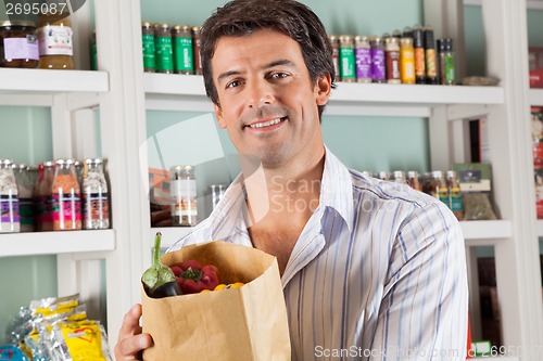 Image of Male Customer With Vegetable Bag In Supermarket