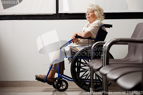 Image of Pensive Elderly Woman On Wheelchair