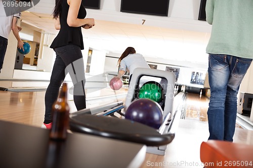 Image of People Playing in Bowling Alley