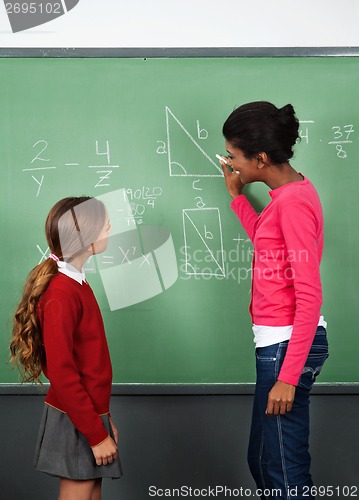 Image of Female Teacher Teaching Mathematics To Schoolgirl