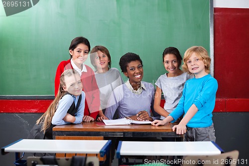 Image of Happy Teacher And Schoolchildren