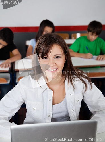 Image of Beautiful Teenage Schoolgirl Sitting With Laptop