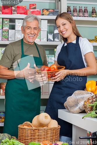 Image of Saleswoman Holding Vegetable Basket Standing With Male Colleague