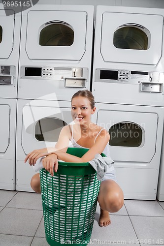 Image of Woman With Clothes Basket In Laundromat