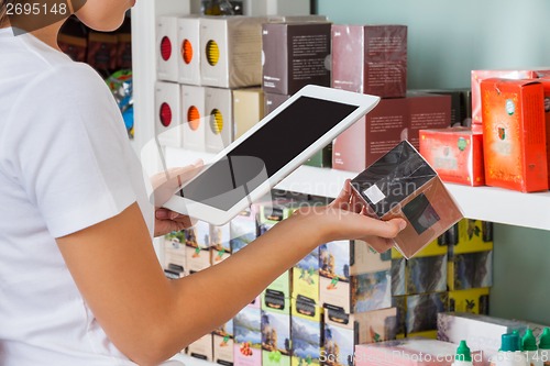 Image of Woman Scanning Barcode Through Digital Tablet