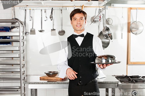 Image of Young Waiter With Cloche Lid Cover And Tray