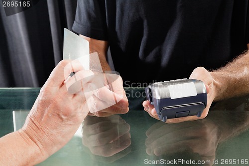 Image of Customer Paying Through Credit Card To Hairstylist