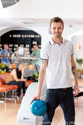 Image of Man With Bowling Ball in Club