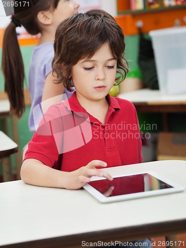 Image of Little Boy Using Digital Tablet In Kindergarten