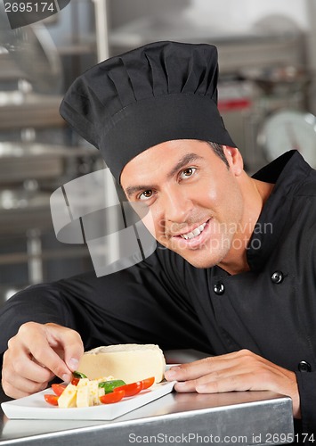 Image of Happy Chef Garnishing Dish