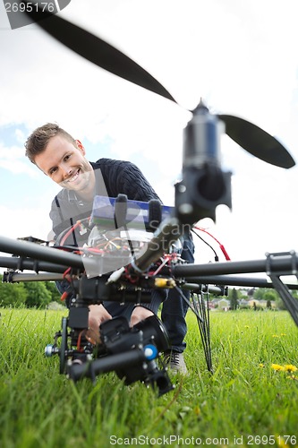 Image of Technician Assembling Camera On UAV Drone