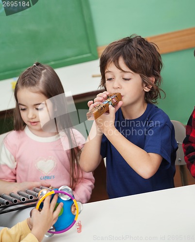 Image of Children Playing Musical Instruments In Classroom