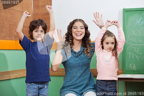 Image of Teacher Playing With Children In Class