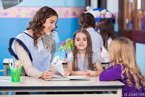Image of Girl With Teacher And Friend In Classroom