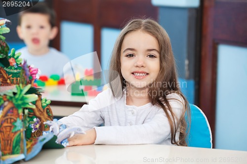 Image of Little Girl With Popup Book In Preschool