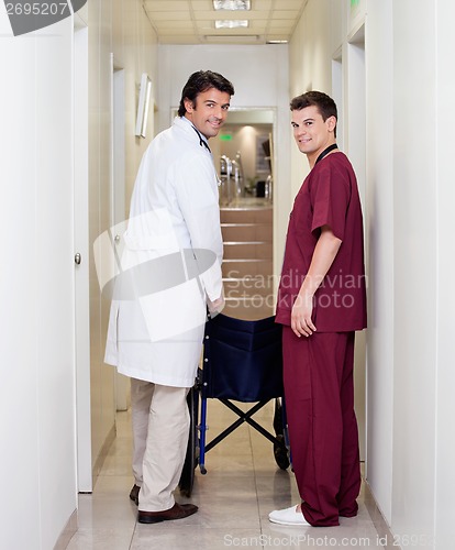Image of Doctor And Male Nurse In Hospital Corridor