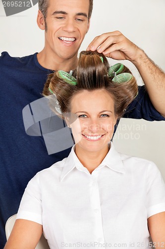 Image of Client With Hairstylist Rolling Her Hair