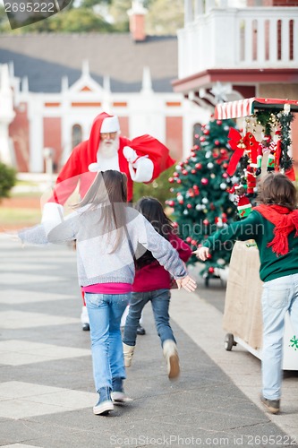 Image of Children Running To Embrace Santa Claus