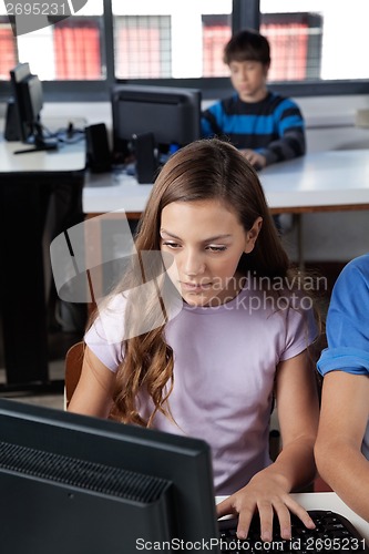 Image of Schoolgirl Using Computer At Desk