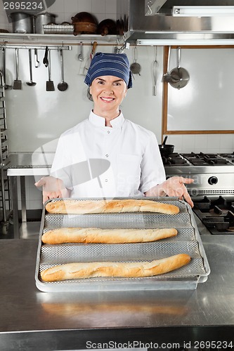 Image of Female Chef Presenting Baked Loafs