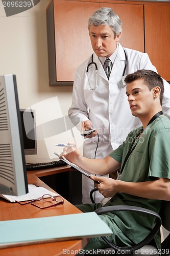 Image of Technician And Doctor Working At Clinic