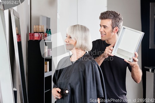 Image of Hairstylist Showing Finished Haircut To Woman