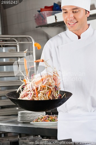 Image of Chef Tossing Vegetables In Air