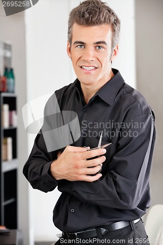 Image of Hairstylist Holding Scissors At Salon