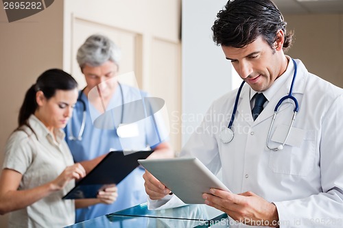 Image of Male Doctor Holding Digital Tablet