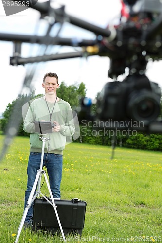 Image of Male Engineer Flying UAV Octocopter