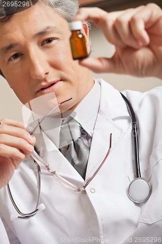 Image of Doctor Holding Medicine Bottle