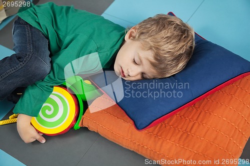 Image of Boy sleeping With Toy In Kindergarten