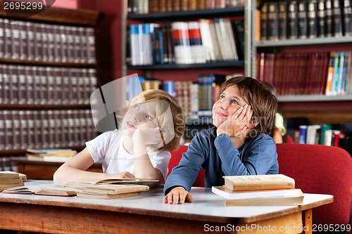 Image of Thoughtful Schoolboys Sitting In Library