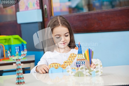 Image of Girl Playing With Craft In Classroom