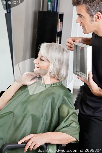 Image of Hairdresser Showing Woman Her Haircut